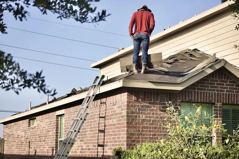 Professional roofer working on a residential roof in East Braintree